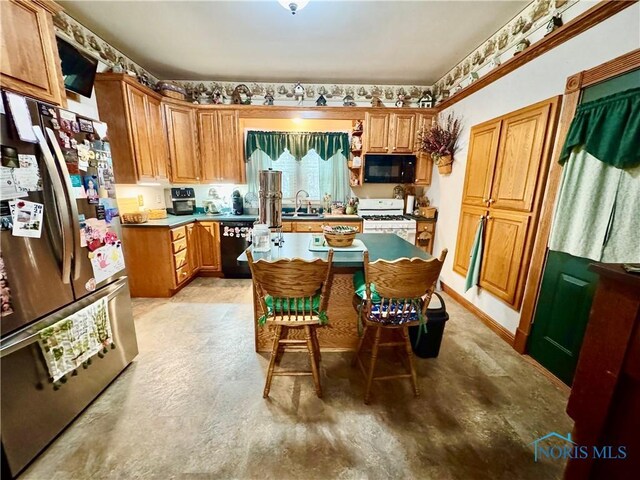 118 N Maple St, Hicksville, OH 43526 - kitchen featuring black appliances and brown cabinetry