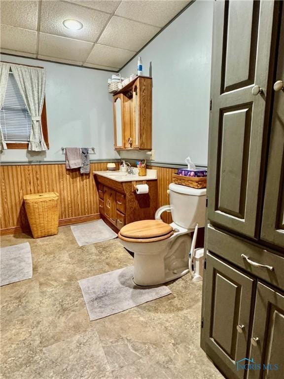 118 N Maple St, Hicksville, OH 43526 - bathroom with toilet, wainscoting, vanity, and a drop ceiling