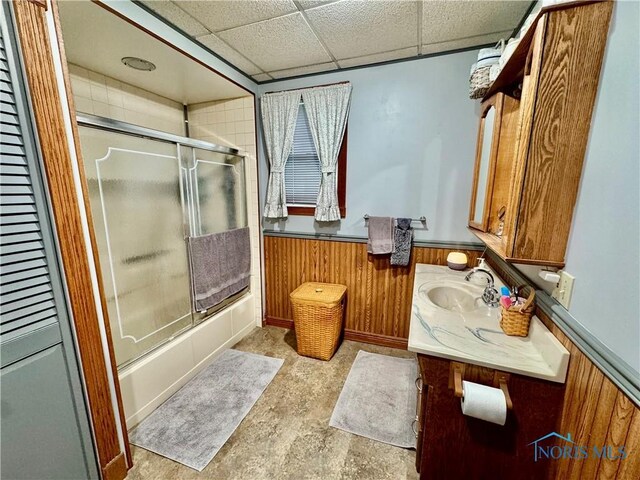 118 N Maple St, Hicksville, OH 43526 - full bath featuring vanity, wainscoting, bath / shower combo with glass door, and wood walls