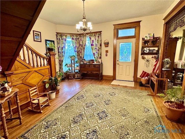 118 N Maple St, Hicksville, OH 43526 - entrance foyer with a chandelier, wood finished floors, healthy amount of natural light, and stairs