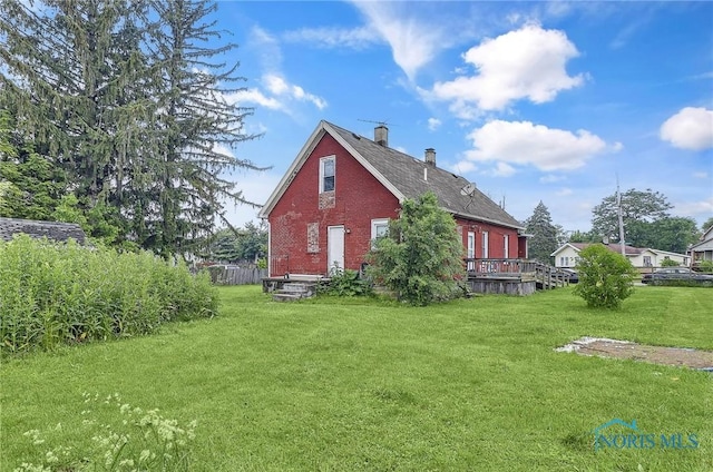 1528 Hirzel St, Toledo, OH 43605 - view of property exterior featuring brick siding, a yard, a chimney, and a deck