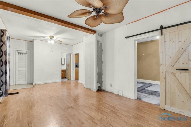 1528 Hirzel St, Toledo, OH 43605 - unfurnished living room featuring a ceiling fan, a barn door, and wood finished floors