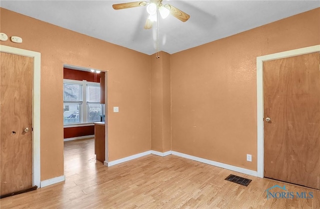 1528 Hirzel St, Toledo, OH 43605 - empty room with wood finished floors, a ceiling fan, and baseboards