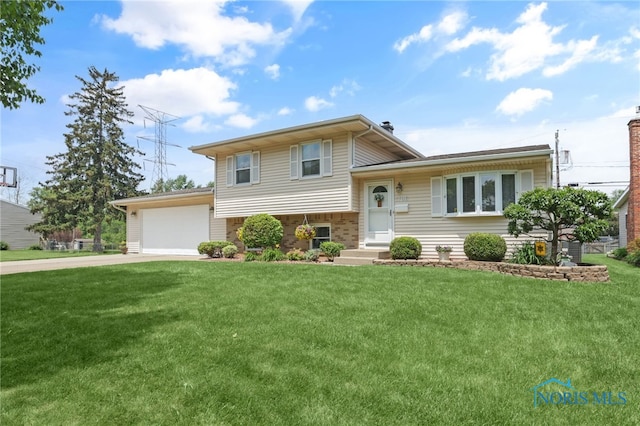 1796 Bucklew Dr, Toledo, OH 43613 - split level home with driveway, a front lawn, and an attached garage