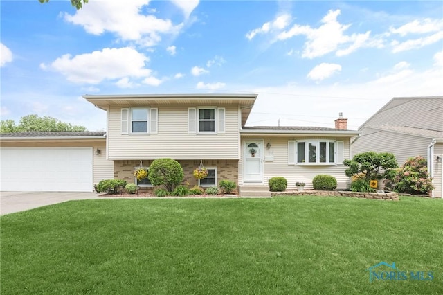 1796 Bucklew Dr, Toledo, OH 43613 - split level home featuring a front lawn, an attached garage, driveway, and brick siding