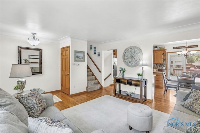 1796 Bucklew Dr, Toledo, OH 43613 - living area with stairway, a chandelier, and light wood finished floors