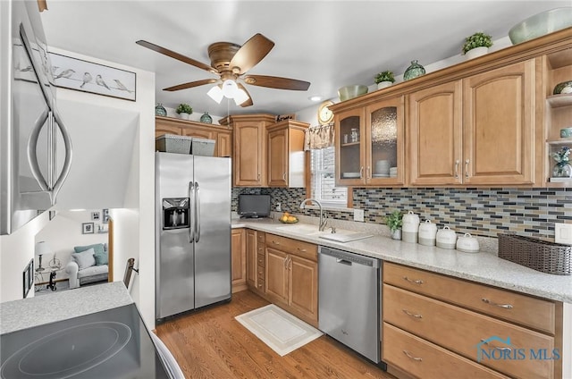 1796 Bucklew Dr, Toledo, OH 43613 - kitchen with stainless steel appliances, a ceiling fan, light wood-type flooring, and tasteful backsplash