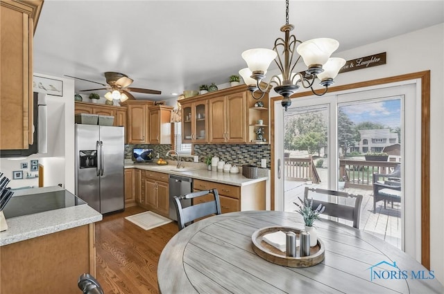 1796 Bucklew Dr, Toledo, OH 43613 - kitchen featuring stainless steel appliances, brown cabinetry, dark wood finished floors, a chandelier, and ceiling fan