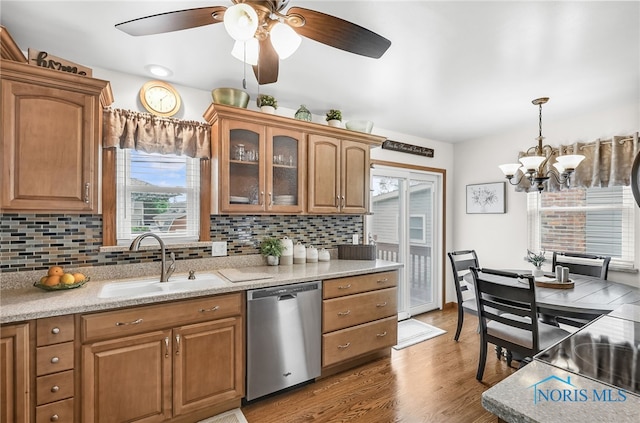 1796 Bucklew Dr, Toledo, OH 43613 - kitchen with dishwasher, brown cabinets, wood finished floors, and decorative backsplash