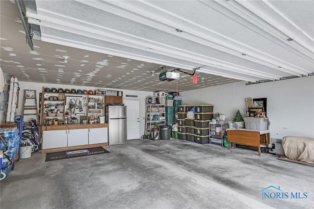 1796 Bucklew Dr, Toledo, OH 43613 - garage with freestanding refrigerator and a garage door opener