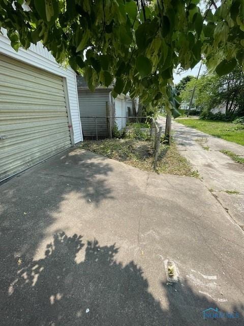 3223 Maple St, Toledo, OH 43608 - view of home's exterior featuring a garage and concrete driveway