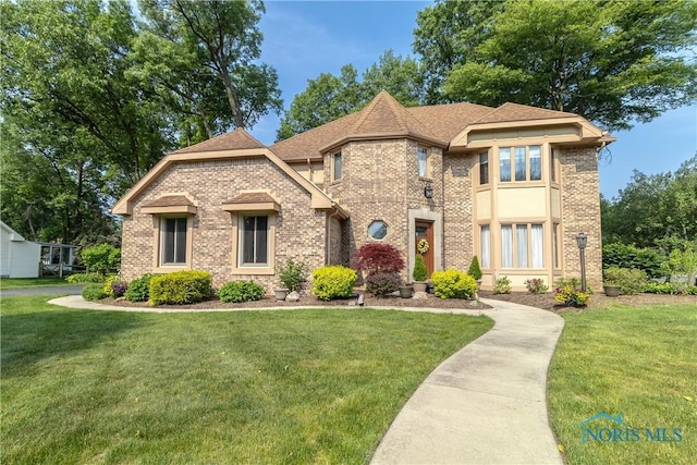 2439 Notting Hill Rd, Toledo, OH 43617 - view of front of home featuring a front yard and brick siding