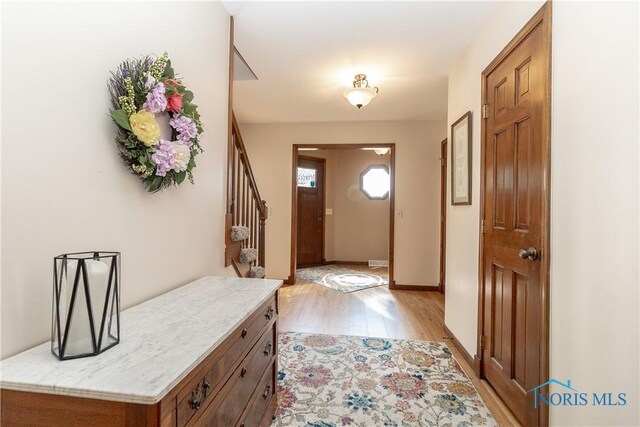 2439 Notting Hill Rd, Toledo, OH 43617 - entryway with light wood-type flooring, stairway, and baseboards