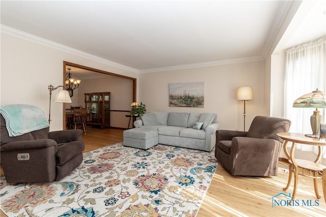 2439 Notting Hill Rd, Toledo, OH 43617 - living room featuring ornamental molding, wood finished floors, and a chandelier