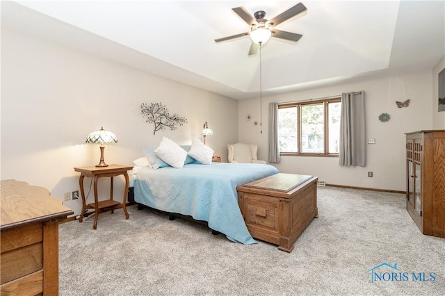 2439 Notting Hill Rd, Toledo, OH 43617 - bedroom featuring light colored carpet, a tray ceiling, ceiling fan, and baseboards