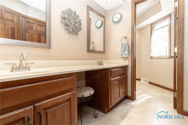 2439 Notting Hill Rd, Toledo, OH 43617 - full bathroom with double vanity, tile patterned flooring, and baseboards