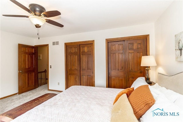 2439 Notting Hill Rd, Toledo, OH 43617 - carpeted bedroom with two closets, a ceiling fan, and baseboards