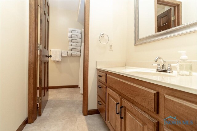 2439 Notting Hill Rd, Toledo, OH 43617 - bathroom with vanity, baseboards, and tile patterned floors
