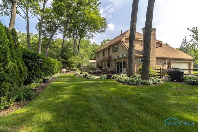 2439 Notting Hill Rd, Toledo, OH 43617 - view of yard featuring a patio area and an attached garage