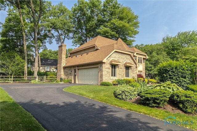 2439 Notting Hill Rd, Toledo, OH 43617 - view of front of home featuring brick siding, driveway, an attached garage, a chimney, and roof with shingles