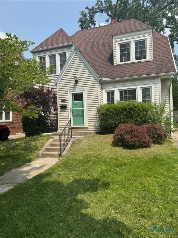 3344 Harley Rd, Toledo, OH 43606 - view of front of home featuring a front yard, entry steps, a chimney, and roof with shingles