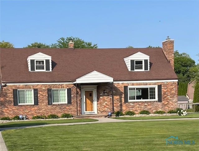 2229 Eastgate Rd, Toledo, OH 43614 - cape cod house with a front lawn, a chimney, and brick siding