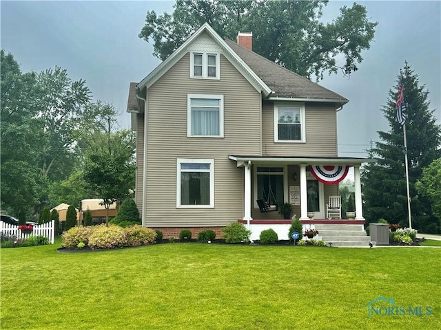 1520 S Clinton St, Defiance, OH 43512 - back of property featuring covered porch, a lawn, a chimney, and central AC