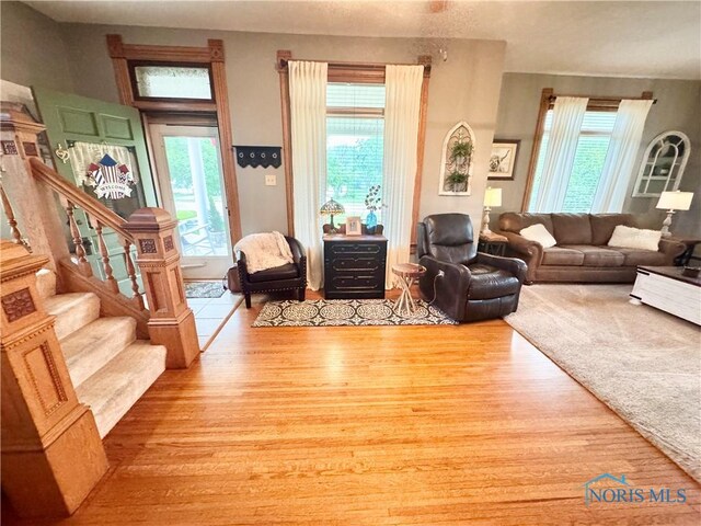 1520 S Clinton St, Defiance, OH 43512 - living room featuring wood finished floors, healthy amount of natural light, and stairs