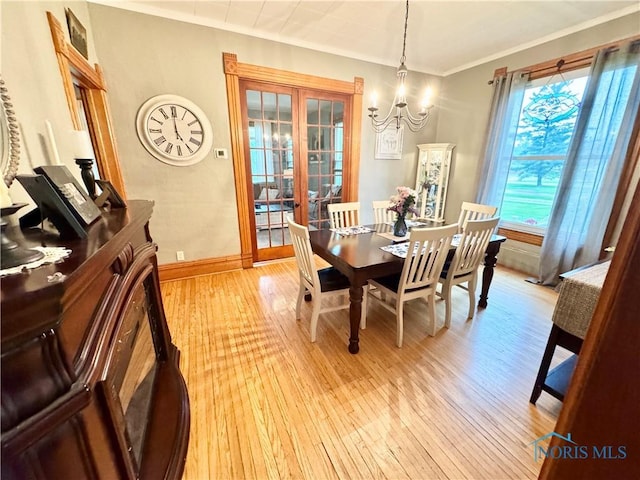 1520 S Clinton St, Defiance, OH 43512 - dining space featuring light wood-style flooring, a chandelier, crown molding, and baseboards