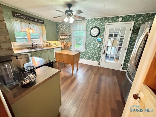 1520 S Clinton St, Defiance, OH 43512 - kitchen with green cabinets, wallpapered walls, a sink, and dark wood finished floors
