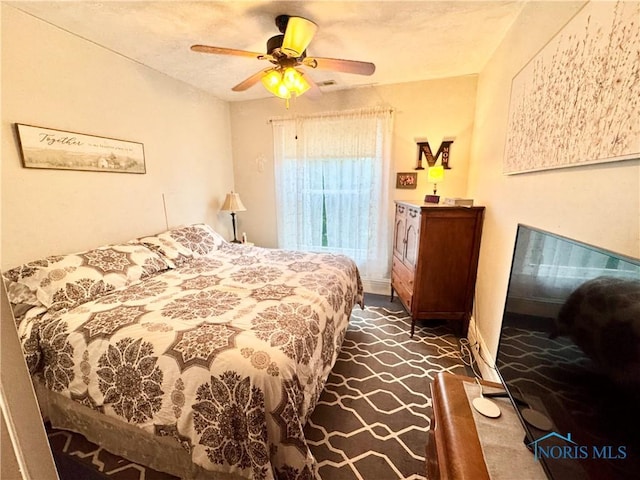 1520 S Clinton St, Defiance, OH 43512 - bedroom featuring ceiling fan, dark colored carpet, and baseboards
