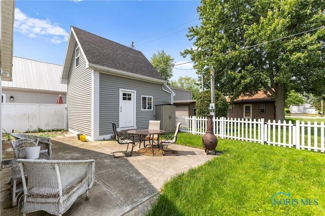 254 N Worthy St, Marblehead, OH 43440 - view of patio / terrace with outdoor dining space and a storage shed