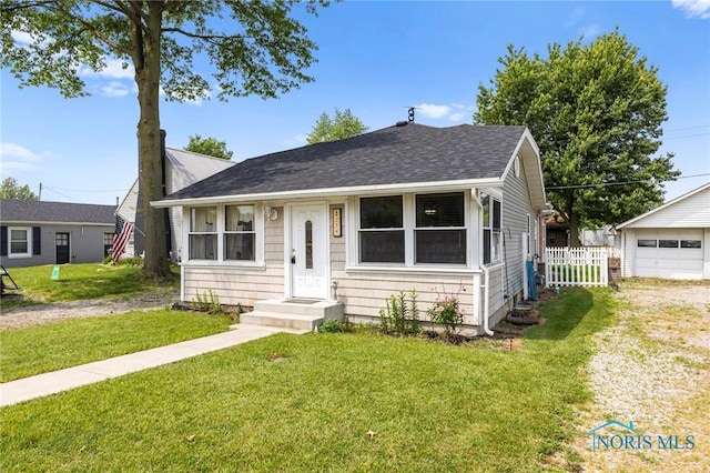254 N Worthy St, Marblehead, OH 43440 - view of front of house featuring a shingled roof and a detached garage