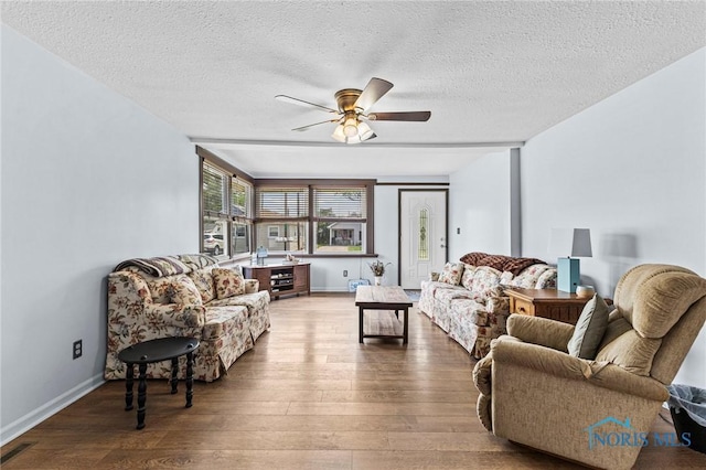 254 N Worthy St, Marblehead, OH 43440 - living room featuring ceiling fan, hardwood / wood-style floors, and a textured ceiling