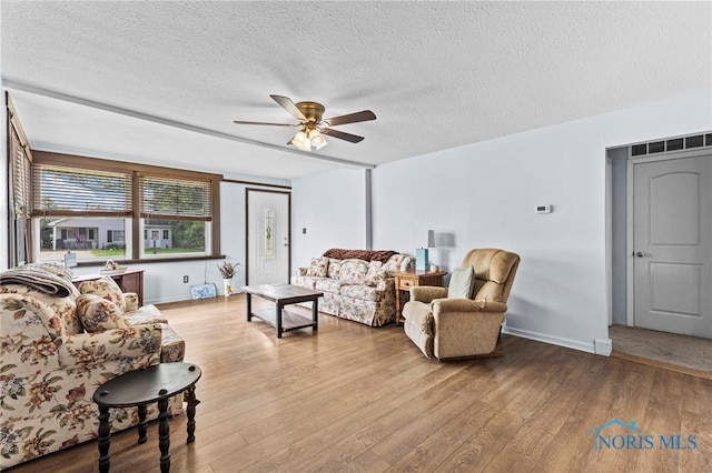 254 N Worthy St, Marblehead, OH 43440 - living room featuring a textured ceiling, ceiling fan, and wood finished floors