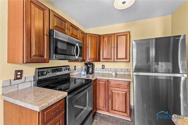 254 N Worthy St, Marblehead, OH 43440 - kitchen with stainless steel appliances, light countertops, and brown cabinets