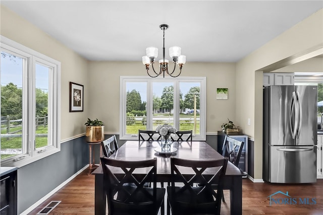826 Touraine Ave, Bowling Green, OH 43402 - dining space featuring a chandelier, baseboards, and dark wood-type flooring