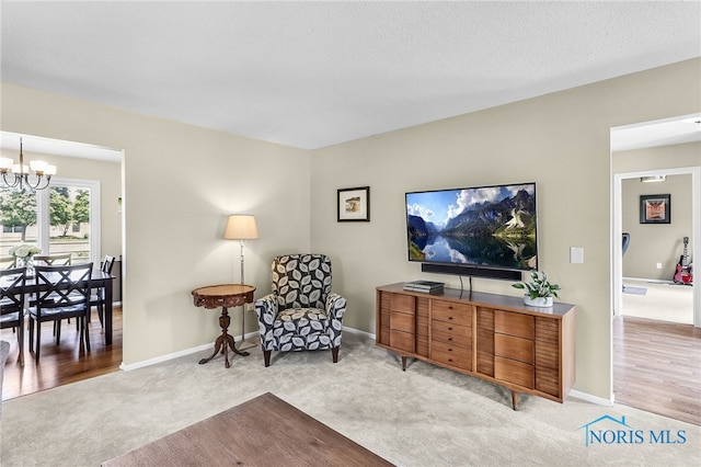 826 Touraine Ave, Bowling Green, OH 43402 - sitting room featuring light carpet, a chandelier, and baseboards
