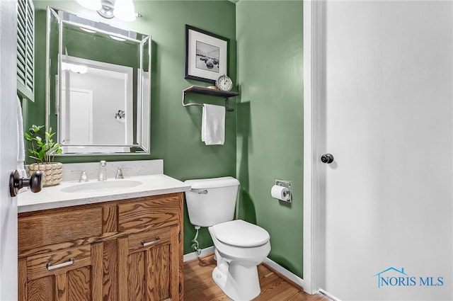 826 Touraine Ave, Bowling Green, OH 43402 - bathroom featuring toilet, wood finished floors, vanity, and baseboards