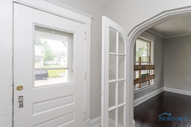 426 Arden Pl, Toledo, OH 43605 - doorway with baseboards, ornamental molding, arched walkways, and wood finished floors