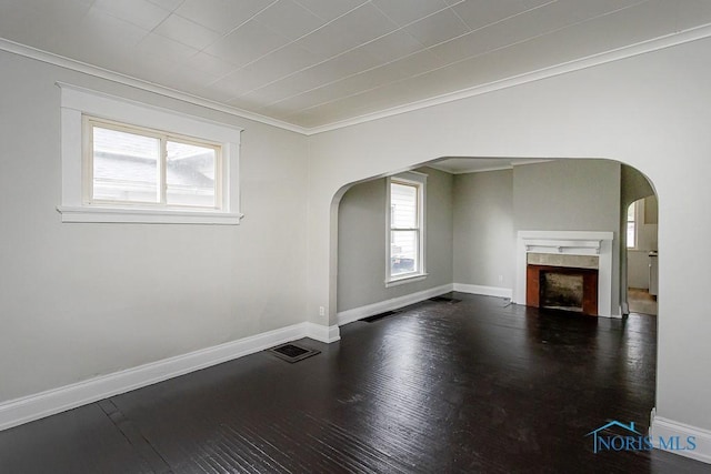 426 Arden Pl, Toledo, OH 43605 - unfurnished living room with arched walkways, wood finished floors, baseboards, and a tile fireplace