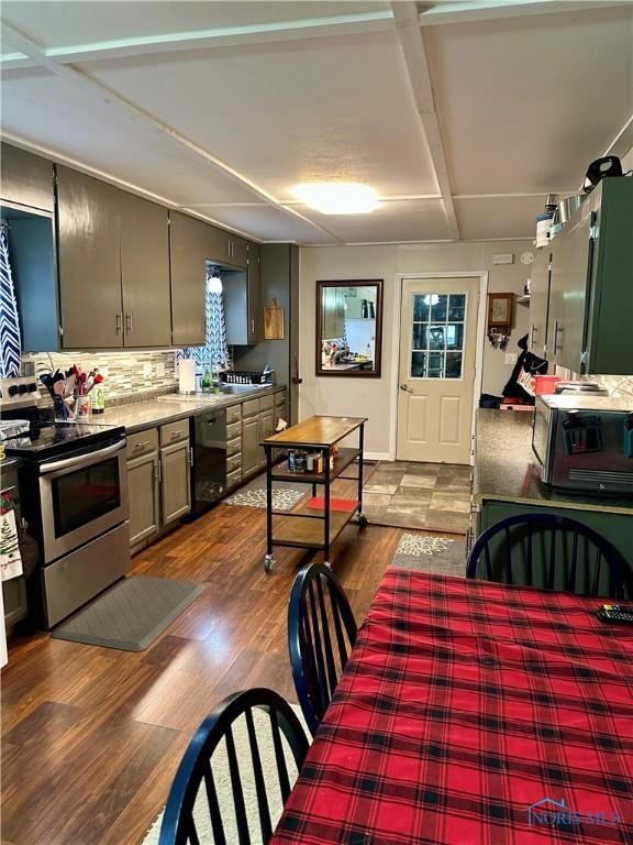 314 Jewett Ave, North Baltimore, OH 45872 - kitchen featuring stainless steel electric stove, black dishwasher, dark wood-style flooring, and backsplash