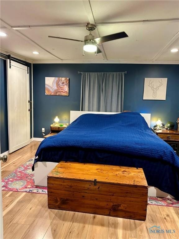 314 Jewett Ave, North Baltimore, OH 45872 - bedroom featuring a barn door, wood finished floors, recessed lighting, and a ceiling fan