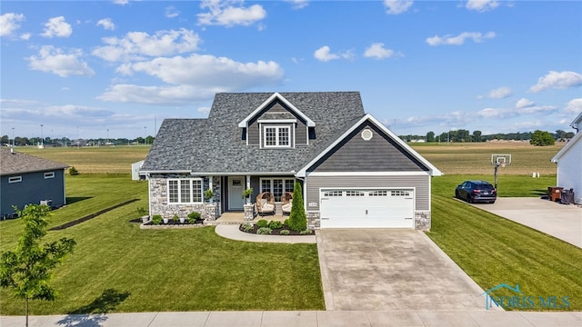 1209 Apache Dr, Wauseon, OH 43567 - view of front of home featuring stone siding, covered porch, a front yard, driveway, and a garage