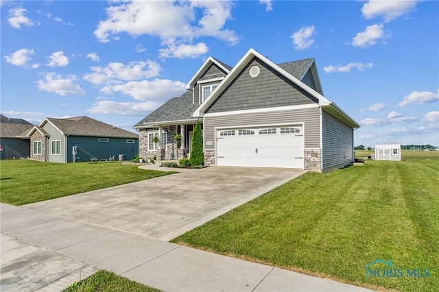 1209 Apache Dr, Wauseon, OH 43567 - craftsman house with a front yard, concrete driveway, stone siding, and a garage