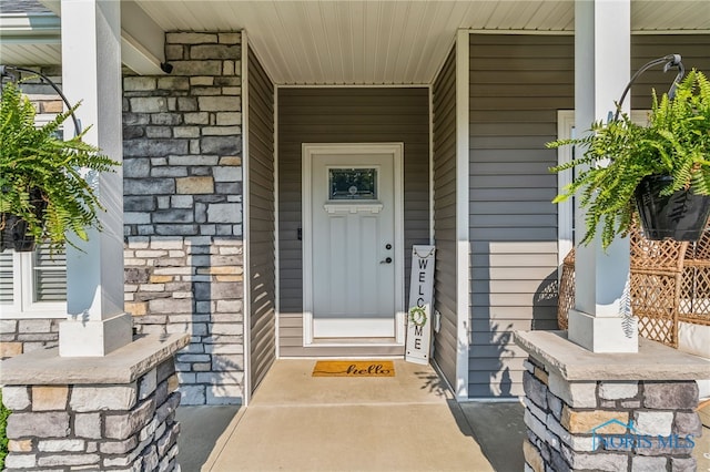 1209 Apache Dr, Wauseon, OH 43567 - property entrance featuring covered porch and stone siding