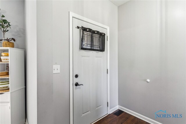1209 Apache Dr, Wauseon, OH 43567 - foyer entrance with dark wood-style floors and baseboards