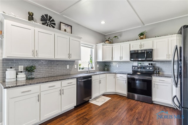 1209 Apache Dr, Wauseon, OH 43567 - kitchen featuring appliances with stainless steel finishes, white cabinets, backsplash, dark stone counters, and recessed lighting