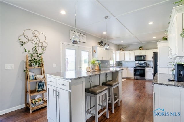 1209 Apache Dr, Wauseon, OH 43567 - kitchen with stainless steel appliances, decorative backsplash, a kitchen island, stone counters, and recessed lighting