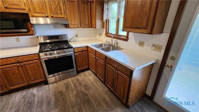 2384 State Route 109, Delta, OH 43515 - kitchen featuring stainless steel gas stove, extractor fan, brown cabinets, and light countertops